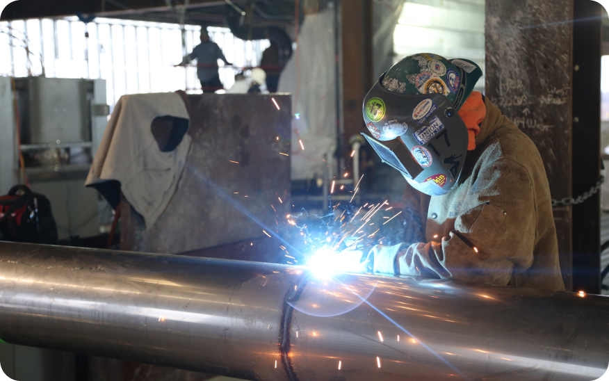 welder welding two pipes together