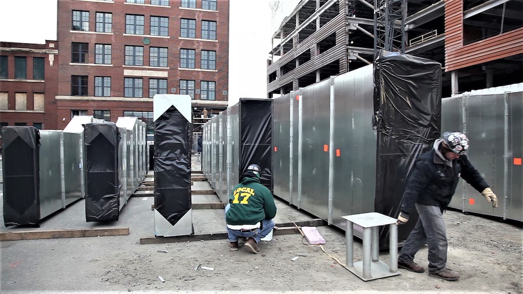 loading ductwork onto roof of building