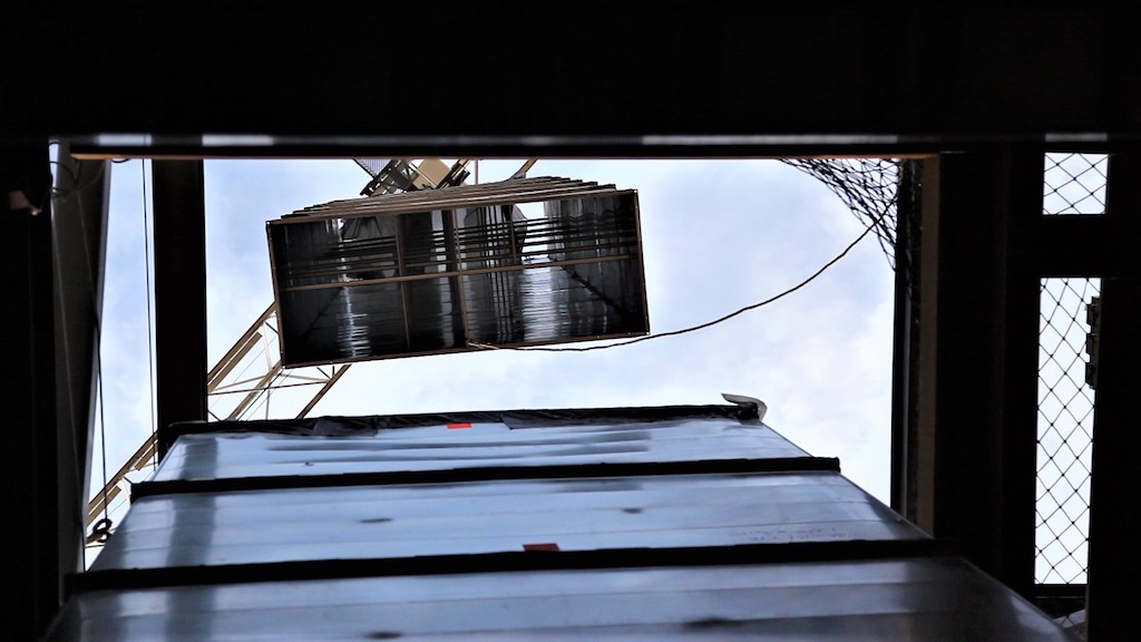 loading ductwork with crane onto building